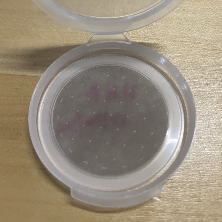 A photograph of 37-mm-diameter Teflon membrane filter with a particulate matter sample on it